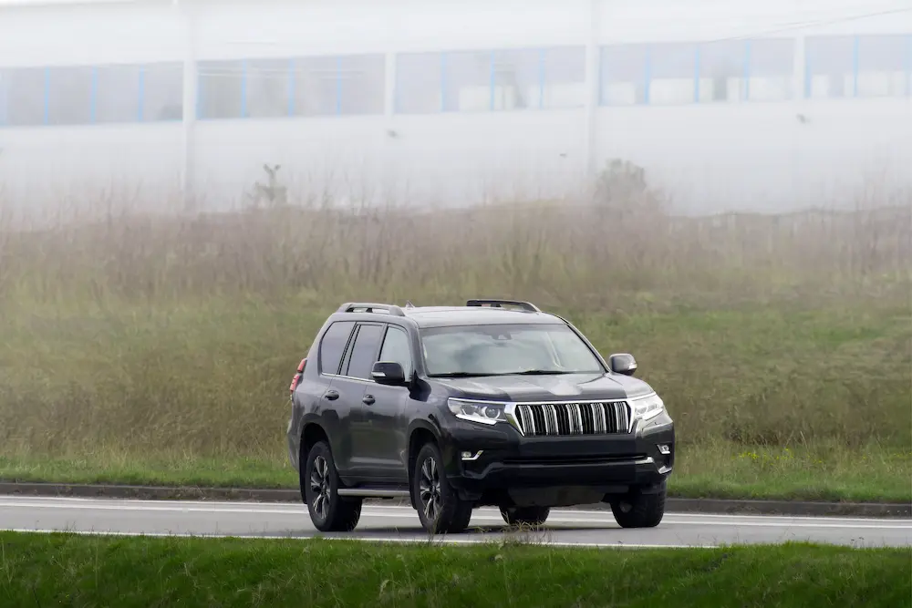 Toyota SUV navigating through a scenic forest trail